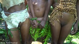 2 African tribe girl having fun with the village chief in the middle of the forrest